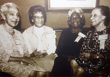 Photograph of four of the twenty-two Delta Sigma Theta founders. Left to right: Winona Cargile Alexander, Bertha Pitts Campbell, Zephyr Chisom Carter and Osceola Macarthy